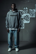 Front view of Uncaved oversized grey hoodie with -Uncaved- wordmark
